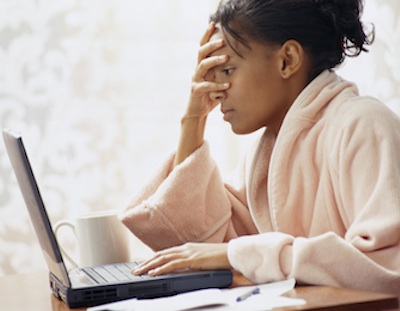 frustrated black woman at laptop